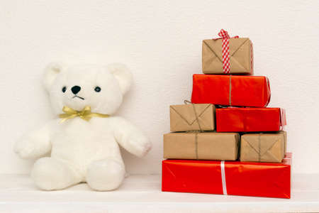 Bear doll with gift boxes on white backgroundの写真素材
