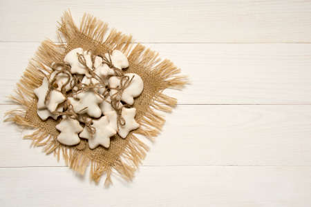 Christmas cookies with sugar-powder and sugar-glaze on white wooden backgroundの写真素材