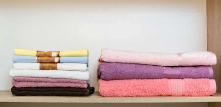 New colour towels pile on shelves in wardrobeの写真素材