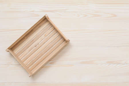 Empty wooden box on white wooden table. Top view. Space for textの写真素材