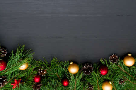 Christmas decoration, garland frame background, top view with copy space on black wood tableの写真素材