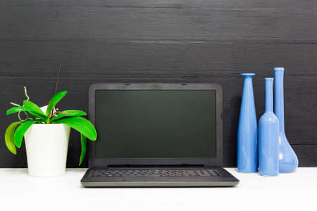 Update software notification in a laptop screen. Computer placed in a wooden work desk.
