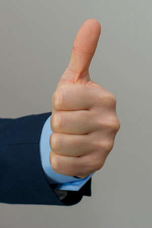 Close-up of professional showing sing of okay.の写真素材