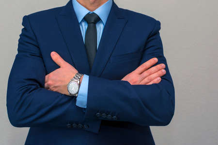 man in suit crossing his arms on chest.の写真素材
