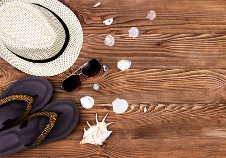 Beach and vacation items on wooden table. Top view with copy spaceの写真素材