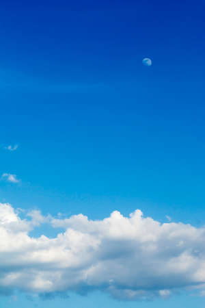 Day blue sky with clouds and moonの写真素材