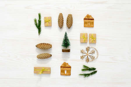 Christmas composition. Christmas gifts, pine cone, on white wooden background. Flat lay, top view