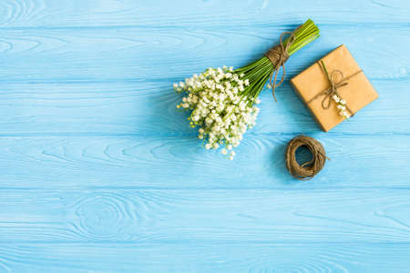 Gift box with spring flower on wooden desk Greeting concept background. top view, flat lay,