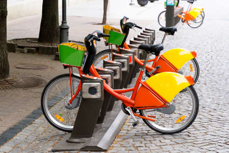 Electric bike rental station in urban setting.