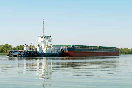 Tanker barge with grain on the Ukraine Dniepr river. Water logistic.の写真素材