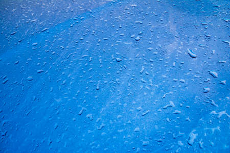 Blue water drops on blue background textureの写真素材
