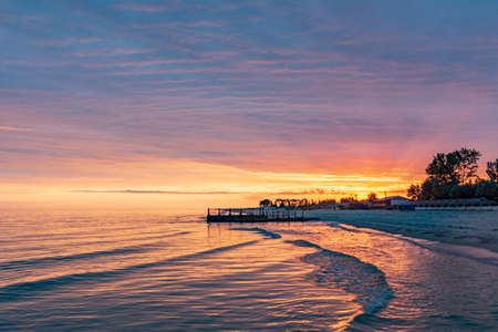 Beautiful sunrise on the old sea pierの写真素材