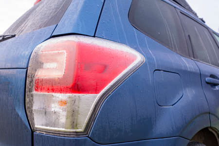 Selective focus of dew on blue car taillight in the morning.の写真素材
