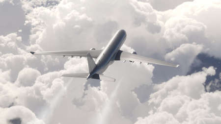 A passenger plane flying above the cloudsの写真素材