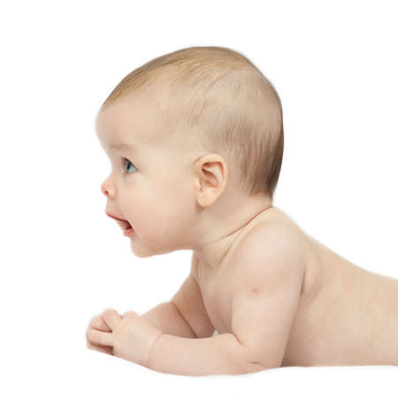 Charming baby. Baby girl lying down on whiteの写真素材