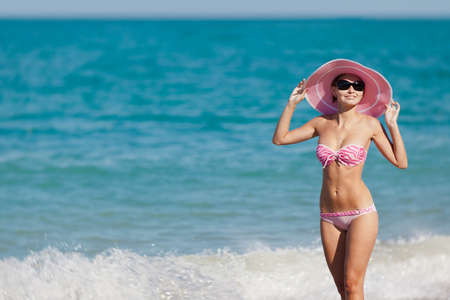 Attractive girl in swimwear at the sea  Young woman posing on seashoreの写真素材