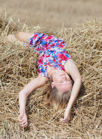 Girl sleeping on a hayloftの写真素材