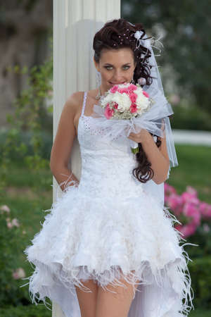Attractive bride in the park  Bride posing looking at camera smilingの写真素材