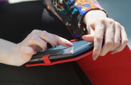 Girl uses touchpad outdoors  Womanの写真素材