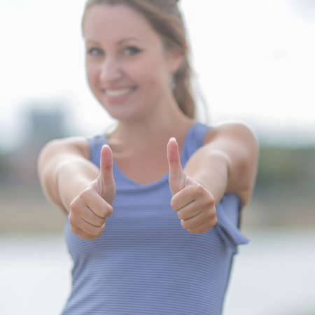 Young woman showing two thumbs up