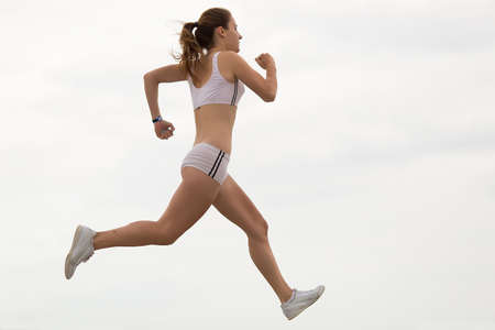 Jogging. Young gymnast on seashoreの写真素材