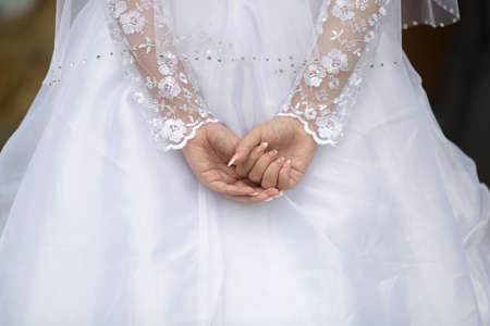 Bride holds her hands behind backの写真素材