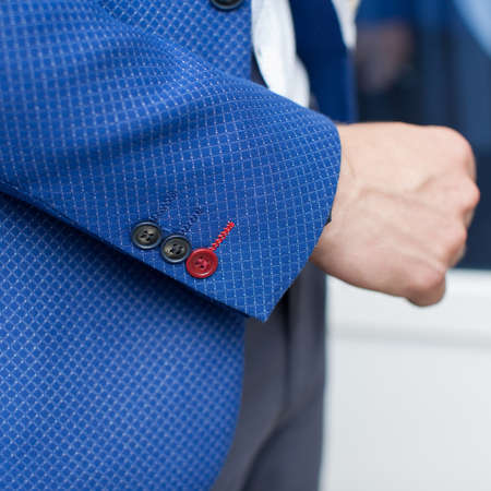 Man's hand in his jacket. Three stylish buttons at cuff jacket