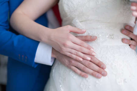 Wedding hands. Hands of bride and groom without wedding rings before wedding ceremonyの写真素材
