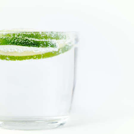 slice of lime in the water with bubbles close-up with shallow depth of field