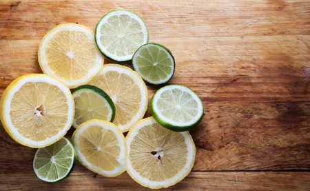 Lemon and limes on rustic wood
