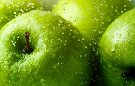 Green apples with water droplets Background, shallow depth of field.の写真素材