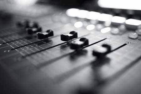 Professional audio mixing console with faders and adjusting knobs,TV equipment Black and White selective focus Professional audio mixing console with faders and adjusting knobs,TV equipment Black and White selective focus