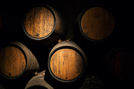 Wine barrels in a old wine cellar Wooden oak wine barrelの写真素材