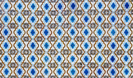 Blue and yellow azulejos on the building's exterior in Lisbon, Portugal.