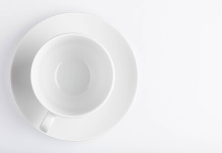 Coffee cup and saucer on a white top view backgroundの写真素材