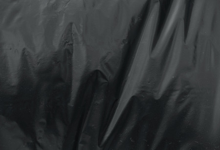 crumpled plastic film texture black garbage bagの写真素材