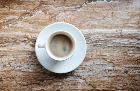 coffee cup on marble table background top viewの写真素材