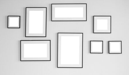 collage of black wooden picture frames on the wall inside the roomの写真素材