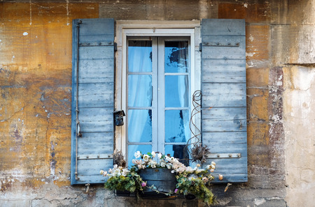 old window with blue shutters and flowersの写真素材