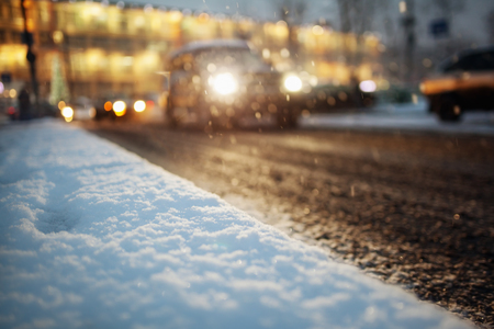 car lights in winter road in city blurred backgroundの写真素材