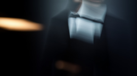 close up of businessman wearing a black tie and a suit  abstract motion blur background with copy...