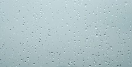 rain drops on window glasses surface natural pattern of raindrops isolated on gray background