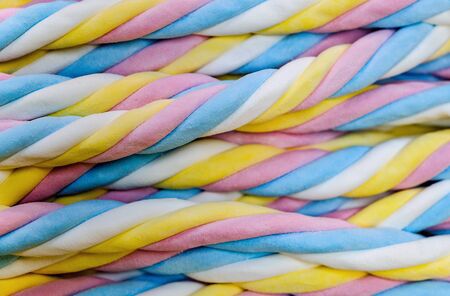 colorful twisted marshmallows candy  close up backgroundの写真素材