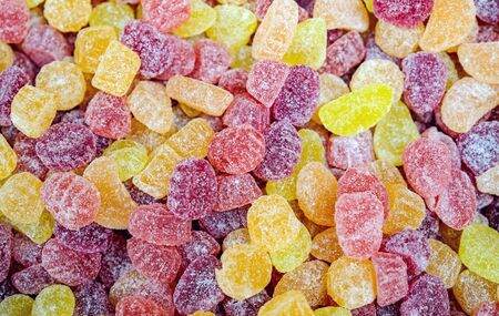 decorative marmalade candy yellow and orange jelly sweet candies  background