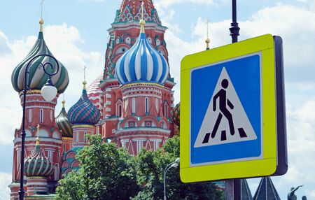 Traffic sign "Pedestrian rossing" on the background of the domes of St. Basil Cathedral in Moscowの写真素材