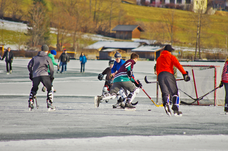 WEISSENSEE,AT - DECEMBER,24 2012 -  Young boys play hockey on the iced surface of the lakeのeditorial素材