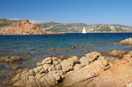 White sailboat along the granite coast of Sardinia, near San Teodoroの写真素材