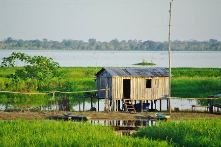 MANAUS, BR - CIRCA AUGUST 2011 - Stilt house on the Amazon river bankのeditorial素材
