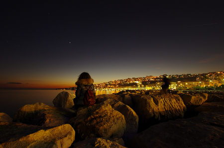 Night view of Naples harbor with tourist, in Italyの写真素材