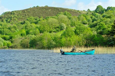 Fisher on a boat on a lake near Castlebar, Irelandのeditorial素材